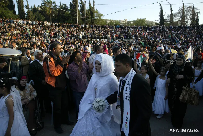 Palestinian brides and grooms take part in a mass wedding ceremony for disabled couples in the West Bank city of Nablus, Thursday, May 12, 2011. The wedding was sponsored by the United Arab Emirates and the Fatah movemen...