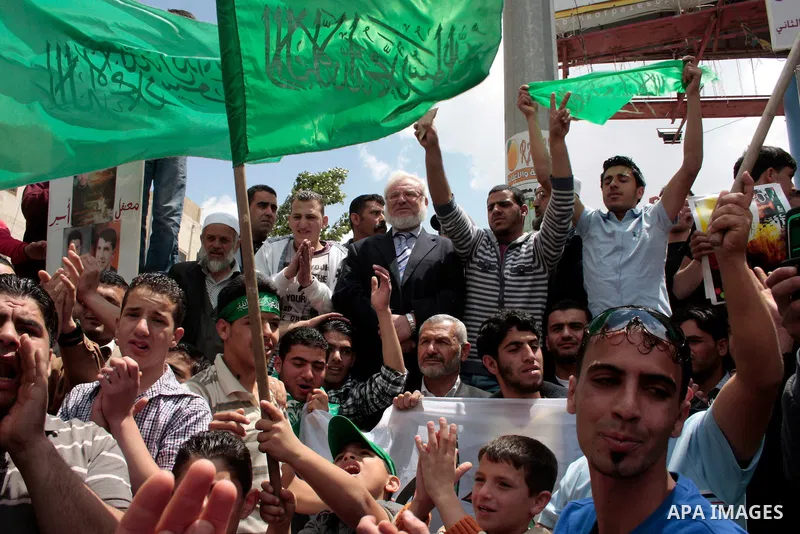 Palestinian parliament speaker, Aziz Dweik and Hamas members of the Palestinian Legislative Council (PLC) take part in a rally to mark the 63th anniversary of "Nakba" (catastrophe) on May 13, 2011 in the West Bank city o...