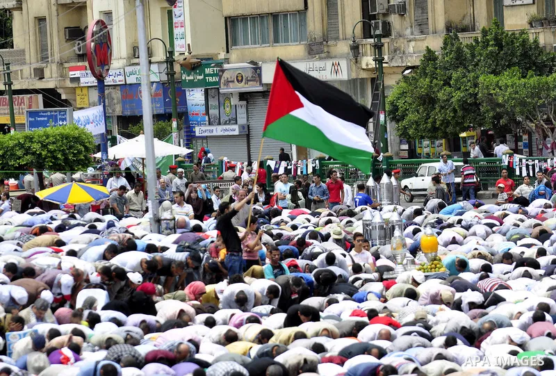 Egyptians attend Friday prayers at a rally at Cairo's Tahrir Square on May 13, 2011 during a protest calling for national unity after attacks on Egyptian churches, and solidarity with the Palestinians as they mark the "N...