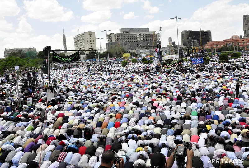 Egyptians attend Friday prayers at a rally at Cairo's Tahrir Square on May 13, 2011 during a protest calling for national unity after attacks on Egyptian churches, and solidarity with the Palestinians as they mark the "N...