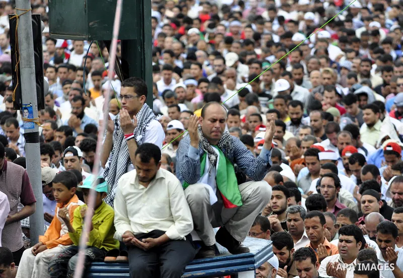 Egyptians attend Friday prayers at a rally at Cairo's Tahrir Square on May 13, 2011 during a protest calling for national unity after attacks on Egyptian churches, and solidarity with the Palestinians as they mark the "N...
