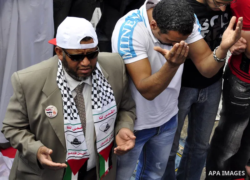 Egyptians attend Friday prayers at a rally at Cairo's Tahrir Square on May 13, 2011 during a protest calling for national unity after attacks on Egyptian churches, and solidarity with the Palestinians as they mark the "N...