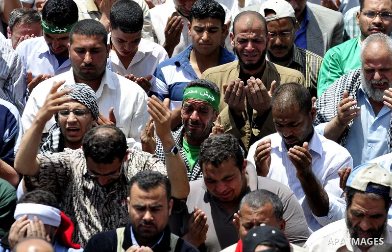 Egyptians attend Friday prayers at a rally at Cairo's Tahrir Square on May 13, 2011 during a protest calling for national unity after attacks on Egyptian churches, and solidarity with the Palestinians as they mark the "N...