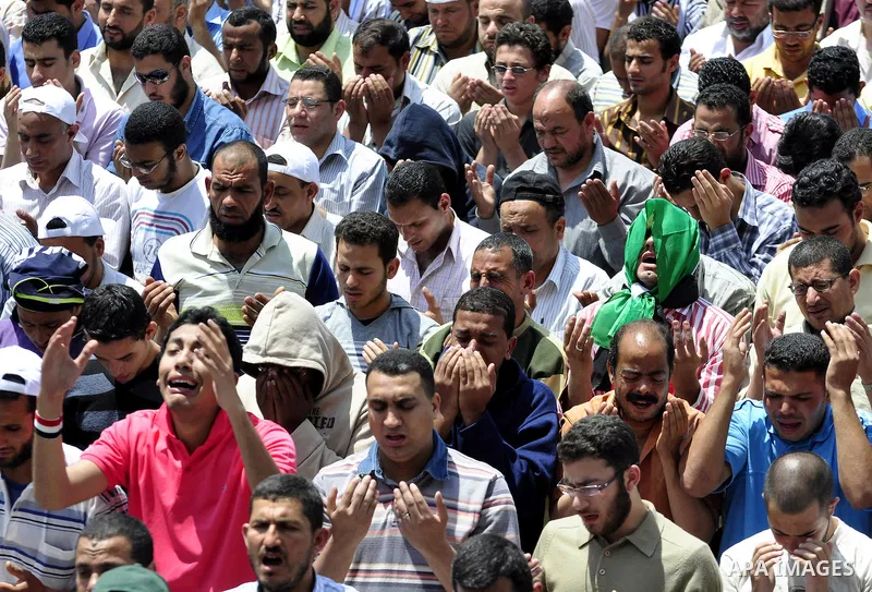 Egyptians attend Friday prayers at a rally at Cairo's Tahrir Square on May 13, 2011 during a protest calling for national unity after attacks on Egyptian churches, and solidarity with the Palestinians as they mark the "N...
