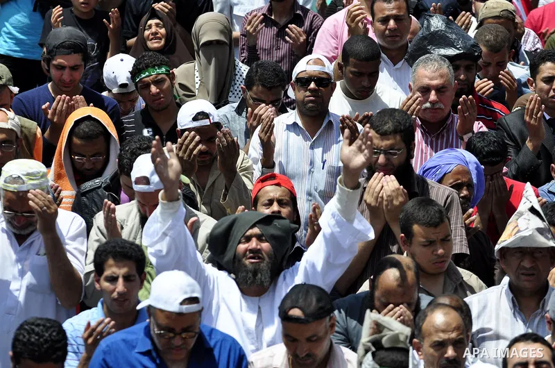 Egyptians attend Friday prayers at a rally at Cairo's Tahrir Square on May 13, 2011 during a protest calling for national unity after attacks on Egyptian churches, and solidarity with the Palestinians as they mark the "N...