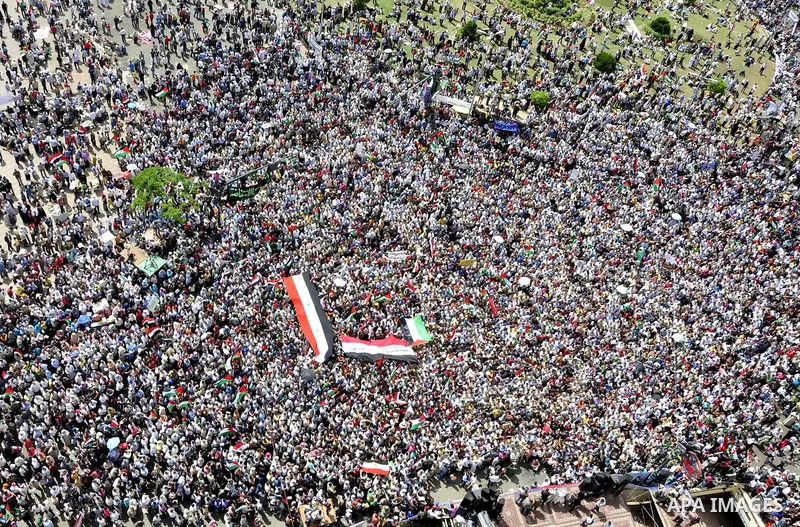 Egyptian demonstrators wave Palestinian flags and Egyptian flags during a rally at Cairo's Tahrir Square on May 13, 2011 during a protest calling for national unity after attacks on Egyptian churches, and solidarity with...