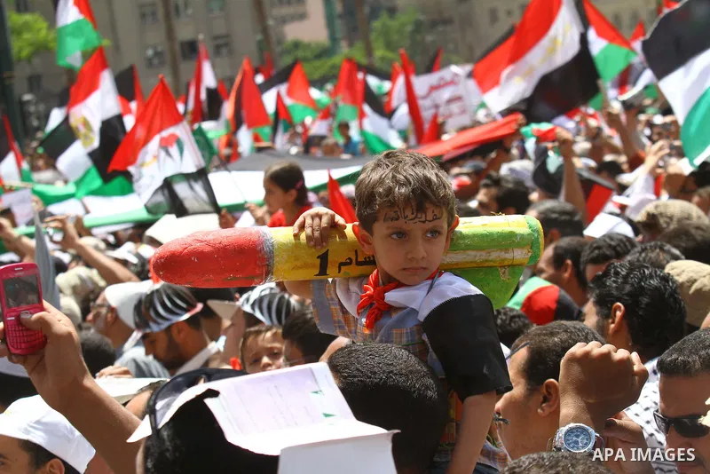 An Egyptian child holds a mock Qassam rocket during a rally at Cairo's Tahrir Square on May 13, 2011 during a protest calling for national unity after attacks on Egyptian churches, and solidarity with the Palestinians as...