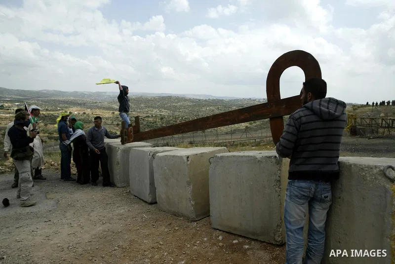 Palestinian protestors carry a big makeshift key during a protest against Israel's controversial separation barrier and to mark the 63th anniversary of "Nakba" (catastrophe) on May 13, 2011in the West Bank village of Bil...