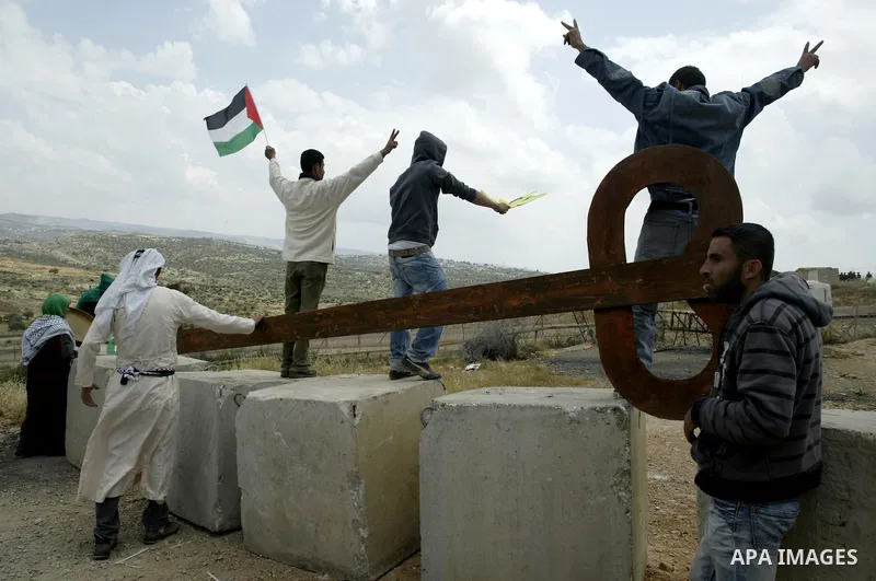 Palestinian protestors carry a big makeshift key during a protest against Israel's controversial separation barrier and to mark the 63th anniversary of "Nakba" (catastrophe) on May 13, 2011in the West Bank village of Bil...