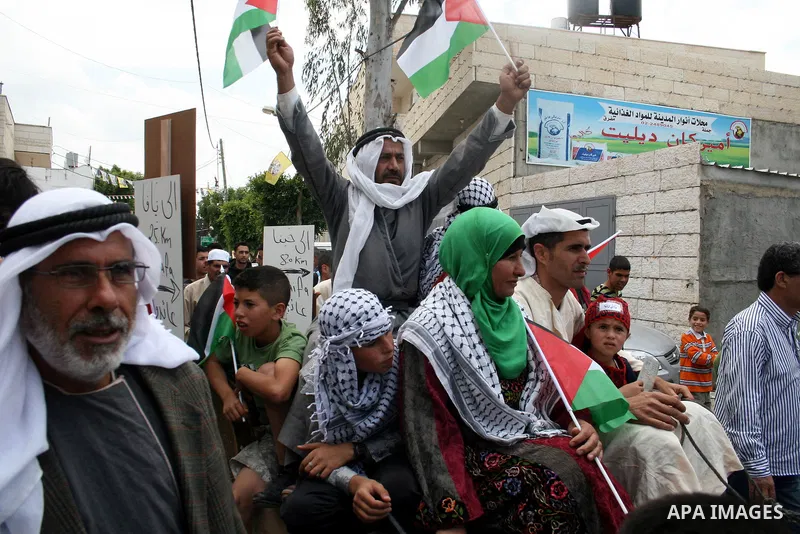Palestinian protestors ride a donkey during a protest against Israel's controversial separation barrier and to mark the 63th anniversary of "Nakba" (catastrophe) on May 13, 2011in the West Bank village of Bilin. Nakba me...