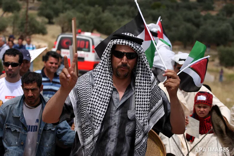 Palestinian protestors ride a donkey during a protest against Israel's controversial separation barrier and to mark the 63th anniversary of "Nakba" (catastrophe) on May 13, 2011in the West Bank village of Bilin. Nakba me...