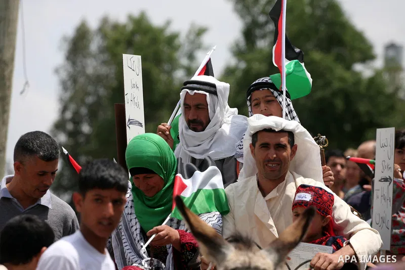 Palestinian protestors ride a donkey during a protest against Israel's controversial separation barrier and to mark the 63th anniversary of "Nakba" (catastrophe) on May 13, 2011in the West Bank village of Bilin. Nakba me...