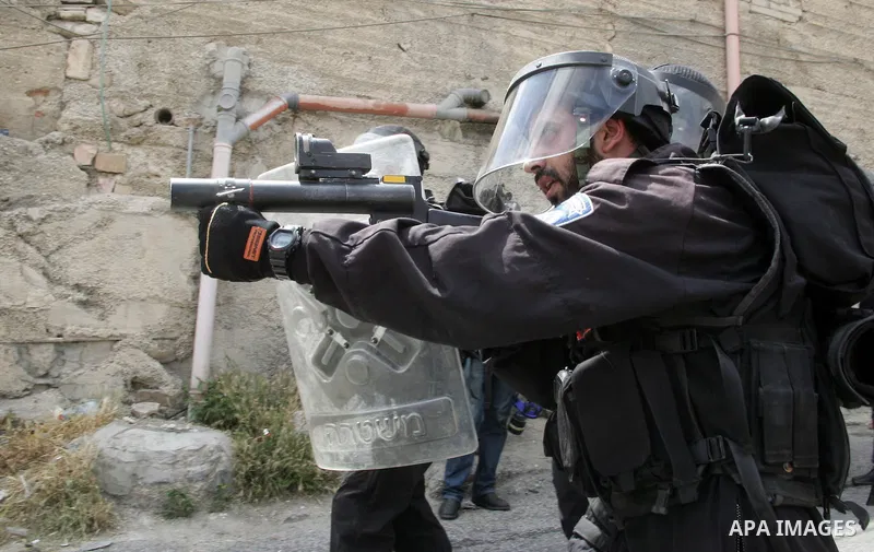 Israeli border policeman takes aim with a teargas grenade launcher in the East Jerusalem neighborhood of A-Tur, on 13 May 2011. Riots broke out in several flashpoints in East Jerusalem following the Friday Prayers. follo...