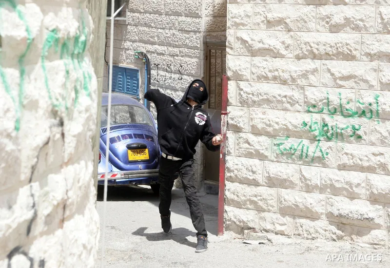 Palestinian youths hurl stones towards Israeli border policemen (not seen) in the East Jerusalem neighborhood of Silwan, on 13 May 2011. Riots broke out in several flashpoints in East Jerusalem following the Friday Praye...