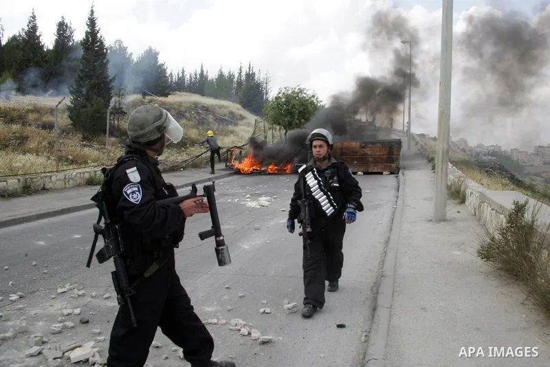 Palestinian youths hurl stones towards Israeli border policemen (not seen) in the East Jerusalem neighborhood of Silwan, on 13 May 2011. Riots broke out in several flashpoints in East Jerusalem following the Friday Praye...
