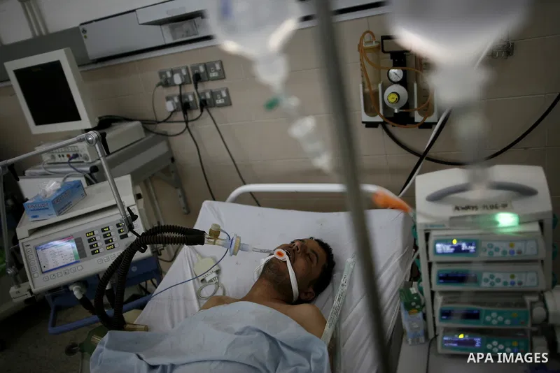 An injured Libyan rebel fighter receives treatment at a hospital after being evacuated from the besieged Libyan city of Misrata at the port in the eastern rebel stronghold of Benghazi on May 13, 2011. A ship carrying inj...