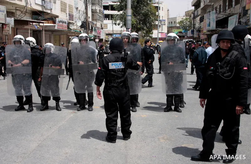 Palestinian security forces block the way of Hamas demonstrators who were trying to reach an Israeli-controlled checkpoint in the West Bank city of Hebron following a rally to mark the 63th anniversary of "Nakba" (catast...