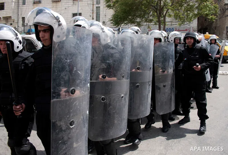Palestinian security forces block the way of Hamas demonstrators who were trying to reach an Israeli-controlled checkpoint in the West Bank city of Hebron following a rally to mark the 63th anniversary of "Nakba" (catast...