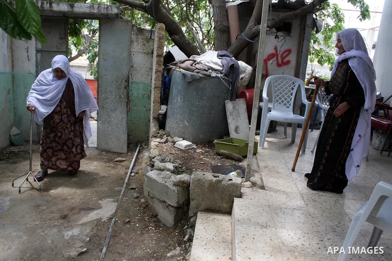 Palestinian refugees stand and holding a key in the Al-Aroub refugee camp near Hebron, on May 14 , 2011 after they was expelled from there original home in 1948. Palestinians commemorate the 63rd anniversary of Nakba, or...