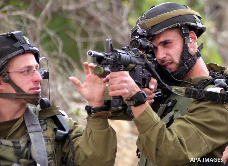 Israeli soldiers shoot the youths Palestinian during clashes in the West Bank city of Hebron on May 15, 2011, while Palestinians mourned on May 15, 2011 the "nakbah" anniversary of Israel's creation in 1948, as a result...
