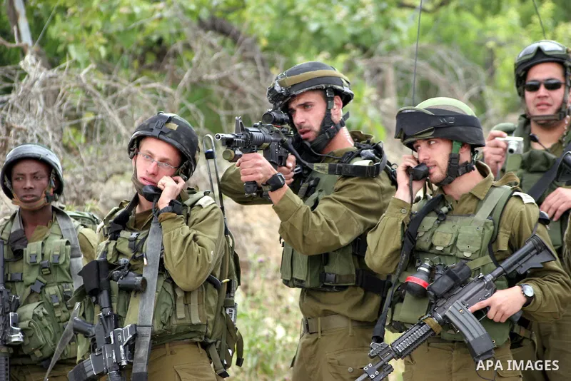Israeli soldiers shoot the youths Palestinian during clashes in the West Bank city of Hebron on May 15, 2011, while Palestinians mourned on May 15, 2011 the "nakbah" anniversary of Israel's creation in 1948, as a result...