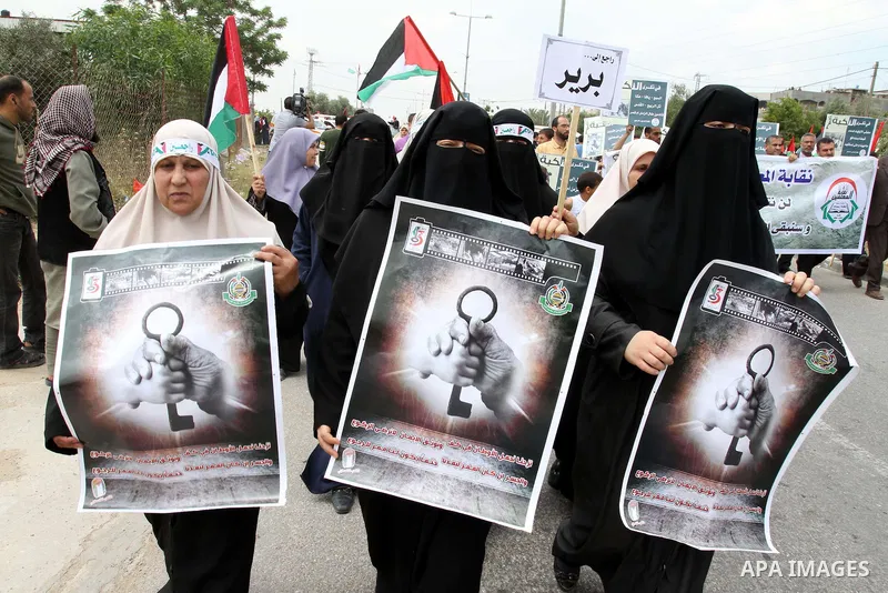 Palestinian protesters wave Palestinian national flags during a demonstration in front of the Erez border crossing in the northern Gaza Strip, on May 15, 2011, as people gathered to mark the "nakbah" or "catastrophe" ann...