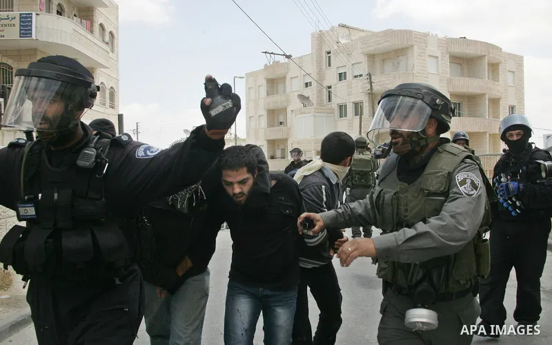 Israeli riot and undercover policemen arrest a Palestinian protester during clashes in the east Jerusalem Arab neighborhood of Issawiya on May 15, 2011 while heavy clashes broke out near Ramallah in the West Bank when yo...