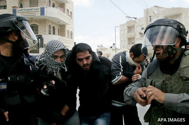 Israeli riot and undercover policemen arrest a Palestinian protester during clashes in the east Jerusalem Arab neighborhood of Issawiya on May 15, 2011 while heavy clashes broke out near Ramallah in the West Bank when yo...