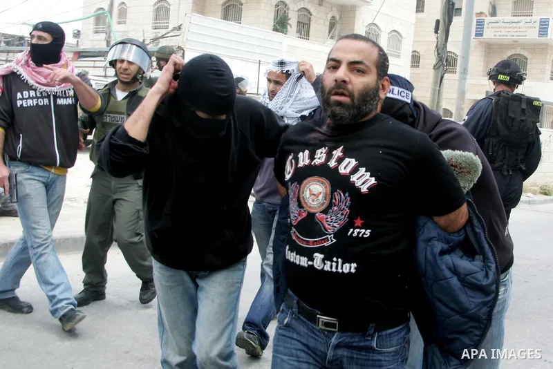 Israeli riot and undercover policemen arrest a Palestinian protester during clashes in the east Jerusalem Arab neighborhood of Issawiya on May 15, 2011 while heavy clashes broke out near Ramallah in the West Bank when yo...