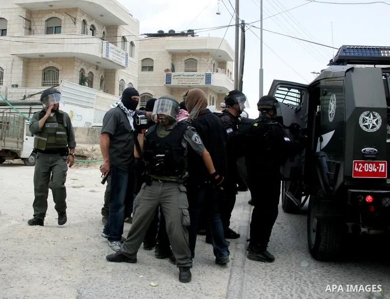 Israeli riot and undercover policemen arrest a Palestinian protester during clashes in the east Jerusalem Arab neighborhood of Issawiya on May 15, 2011 while heavy clashes broke out near Ramallah in the West Bank when yo...