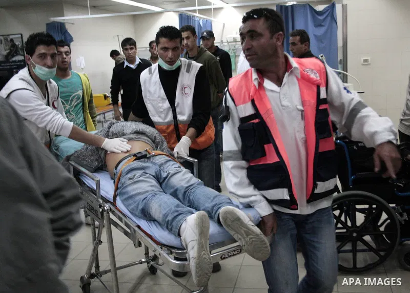 A Palestinian youth receives treatment at a hospital after he wounded when Israeli troops opened fire during confrontations in the restive West Bank city of Hebron as heavy clashes broke out near Ramallah and Jerusalem w...