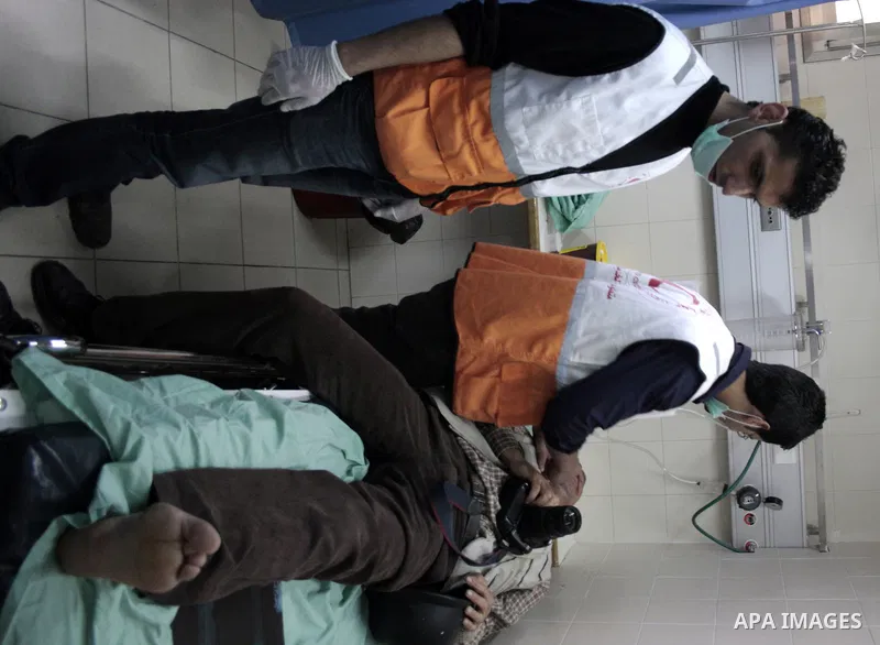 A Palestinian photographer Najeh Hashlamoun receive treatment at a hospital after he wounded when Israeli troops opened fire during confrontations in the restive West Bank city of Hebron as heavy clashes broke out near R...