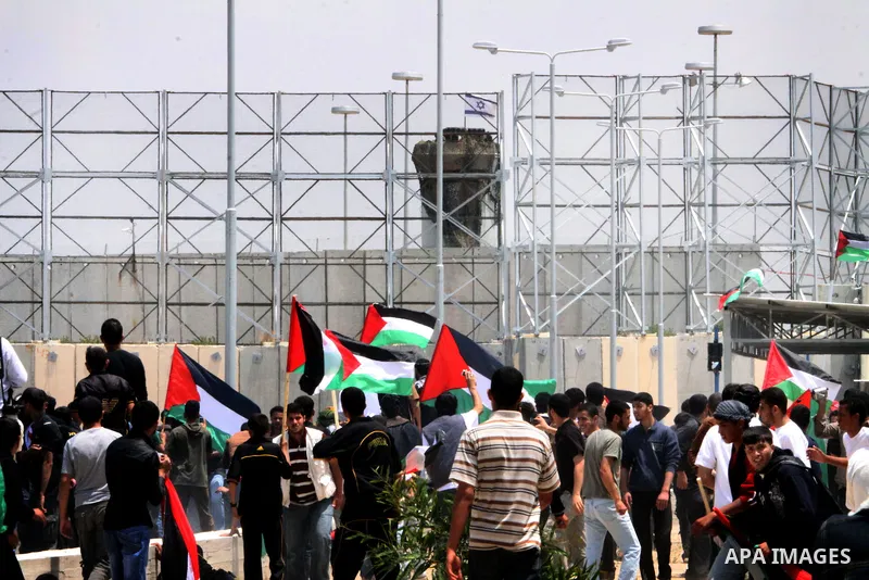 Palestinian protesters march towards the Erez border crossing in the northern Gaza Strip on May 15, 2011 to mark the "Nakba" or "Catastrophe" anniversary of Israel's creation in 1948, as a result of which more than 760,0...