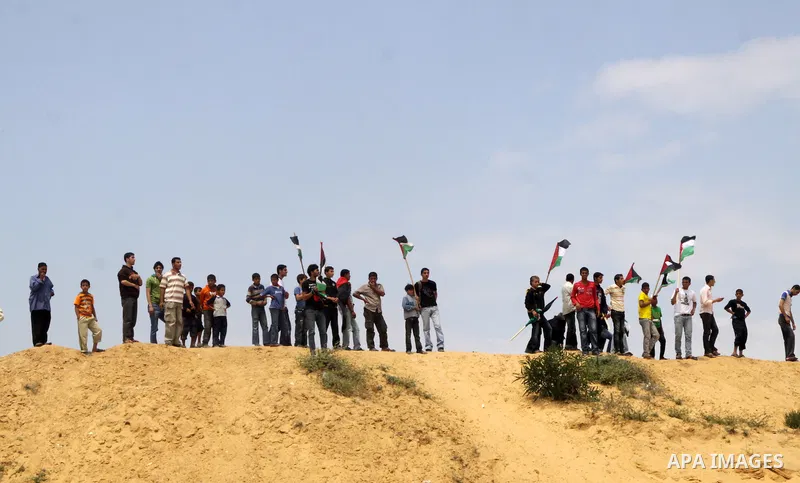 Palestinian protesters march towards the Erez border crossing in the northern Gaza Strip on May 15, 2011 to mark the "Nakba" or "Catastrophe" anniversary of Israel's creation in 1948, as a result of which more than 760,0...
