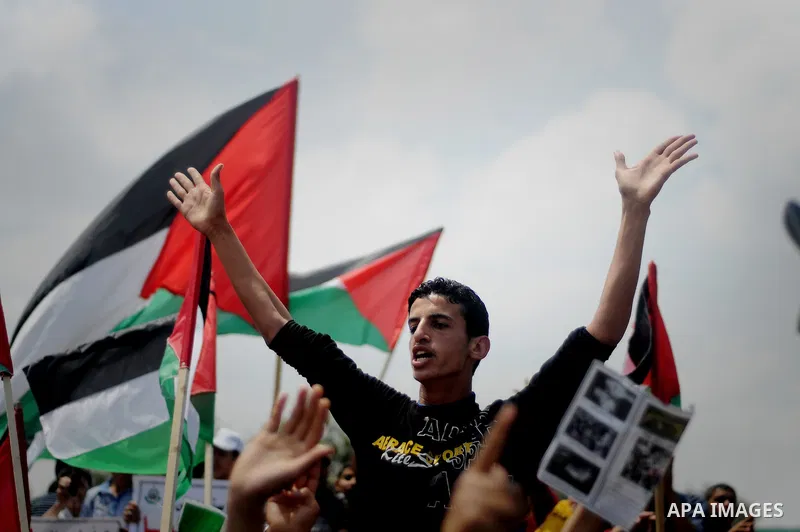 Protesters wave Palestinian flags as they march towards the Erez border crossing in the northern Gaza Strip on May 15, 2011 to mark the "Nakba" or "Catastrophe" anniversary of Israel's creation in 1948, as a result of wh...