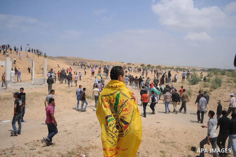 Protesters wave Palestinian flags as they march towards the Erez border crossing in the northern Gaza Strip on May 15, 2011 to mark the "Nakba" or "Catastrophe" anniversary of Israel's creation in 1948, as a result of wh...