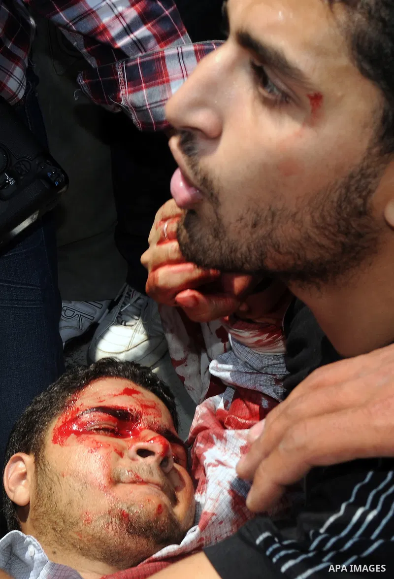 Palestinian youths carry freelance photographer Mohammed Othman after he wounded when Israeli troops opened fire during on a massive march heading towards the Erez border crossing in the northern Gaza Strip, on May 15, 2...