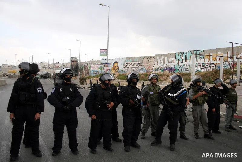 Israeli soldiers take position during clashes with stone throwers at the Israeli manned Qalandia checkpoint between Jerusalem and the West Bank city of Ramallah on May 15, 2011. Palestinians across the Israeli occupied t...