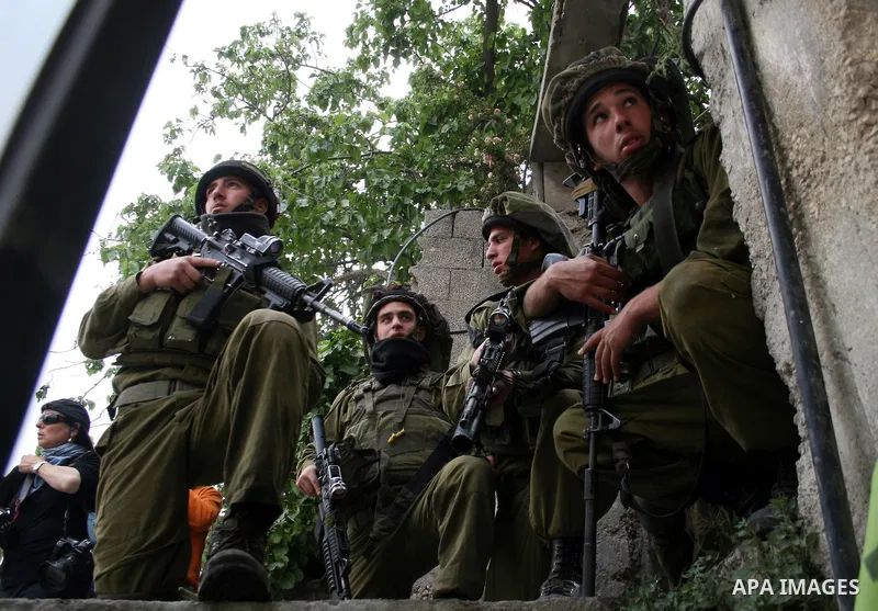 Israeli soldiers take position during clashes with stone throwers at the Israeli manned Qalandia checkpoint between Jerusalem and the West Bank city of Ramallah on May 15, 2011. Palestinians across the Israeli occupied t...