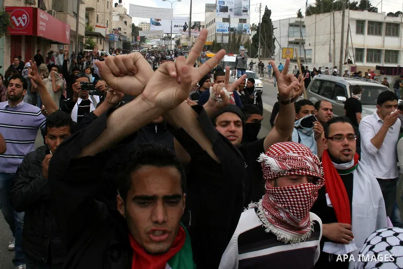 Palestinians march towards the Israeli manned Qalandia checkpoint between Jerusalem and the West Bank city of Ramallah on May 15, 2011. Palestinians across the Israeli occupied territories rallied to mark the 63rd annive...