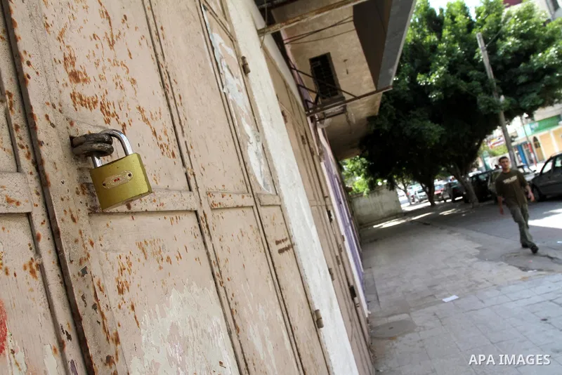 Palestinians walk passed closed shops during a general strike in Gaza Strip on May 16, 2011, to mourn for what israeli occupation done yesterday of shedding the blood of the citizens and Suppression rights of journalists...