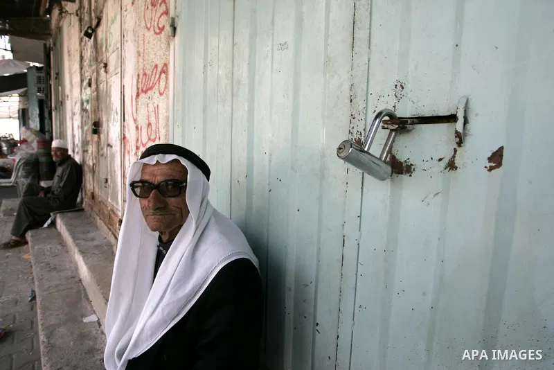 Palestinians walk passed closed shops during a general strike in the southern Gaza Strip town of Rafah on May 16, 2011, to mourn for what israeli occupation done yesterday of shedding the blood of the citizens and Suppre...