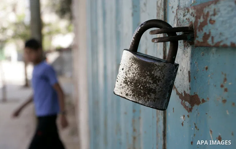 Palestinians walk passed closed shops during a general strike in the southern Gaza Strip town of Rafah on May 16, 2011, to mourn for what israeli occupation done yesterday of shedding the blood of the citizens and Suppre...