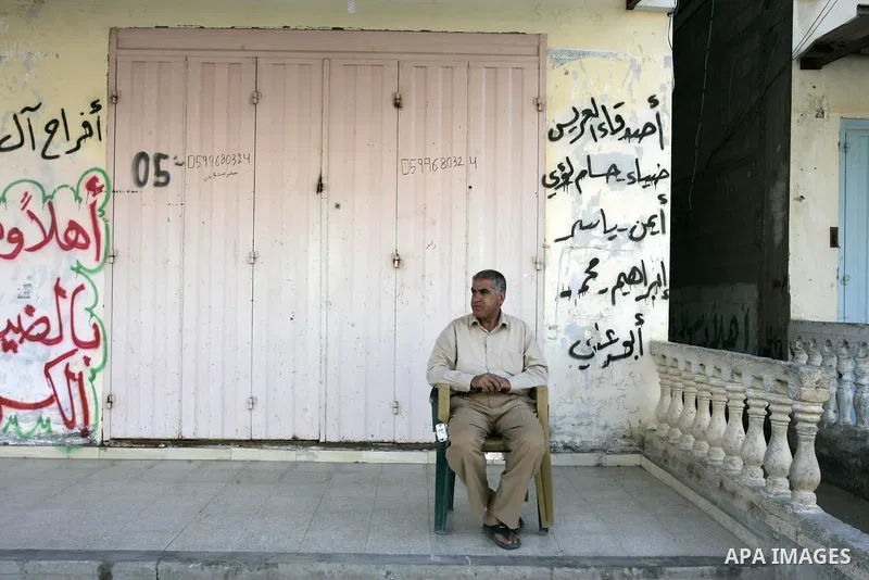 Palestinians walk passed closed shops during a general strike in the southern Gaza Strip town of Rafah on May 16, 2011, to mourn for what israeli occupation done yesterday of shedding the blood of the citizens and Suppre...