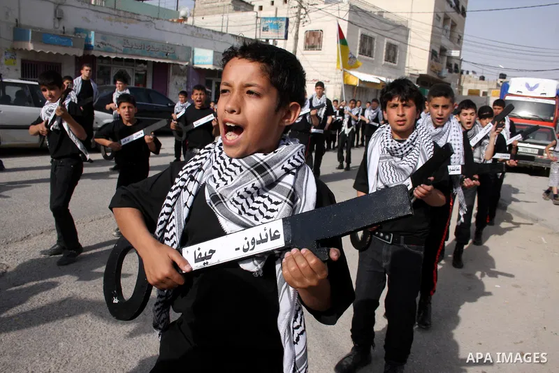 Palestinian boys hold symbolic keys as they take part in a rally marking "Nakba" in the West Bank city of Ramallah May 16, 2011. Palestinians mark the "Nakba", or "catastrophe", on Sunday to commemorate the expulsion or...