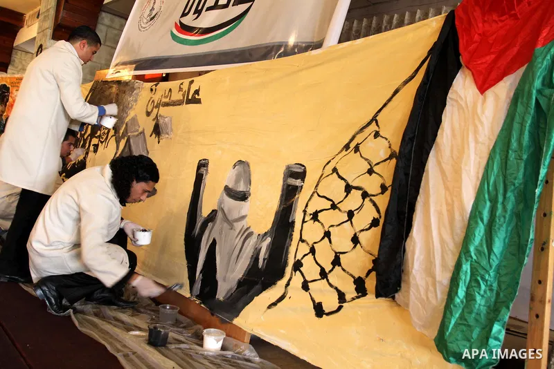 Palestinian artists take part in paint a murals to mark the 63th anniversary of "Nakba" (catastrophe), in Gaza City, on May 18, 2011. Hundreds of thousands of Palestinians were uprooted in the 1948 war that led to Israel...