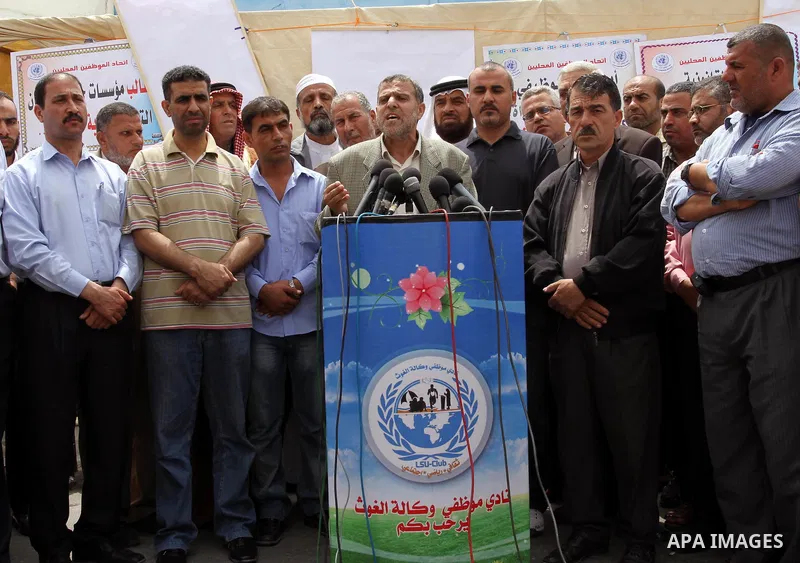 Palestinian employees strike and deliver a speach during a press conference in front of United Nations Relief and Works Agency (UNRWA) in Gaza City May 18, 2011. they as UN Palestinian employees stage a one day-strike de...