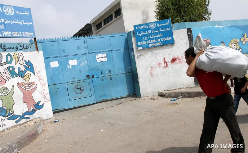 Palestinian man walks past a United Nations Relief and Works Agency (UNRWA) closed school in Gaza City May 18, 2011 as UN Palestinian employees stage a one day-strike demanding higher wages. Some 16 thousand Palestinians...