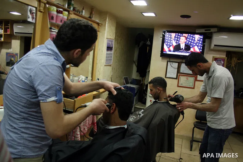 Palestinians watch TV in the West Bank city of Ramallah as the US President Barack Obama speaks on the events in the Middle East and North Africa at the State Department in Washington, DC, May 19, 2011. Obama said that t...