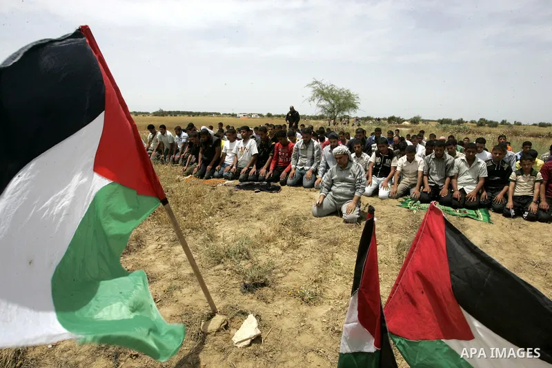 Palestinians pray during a protest near the town of Khan Yunis, close to the border between Israel and the southern Gaza Strip, on May 20, 2011. Photo by Abed Rahim Khatib